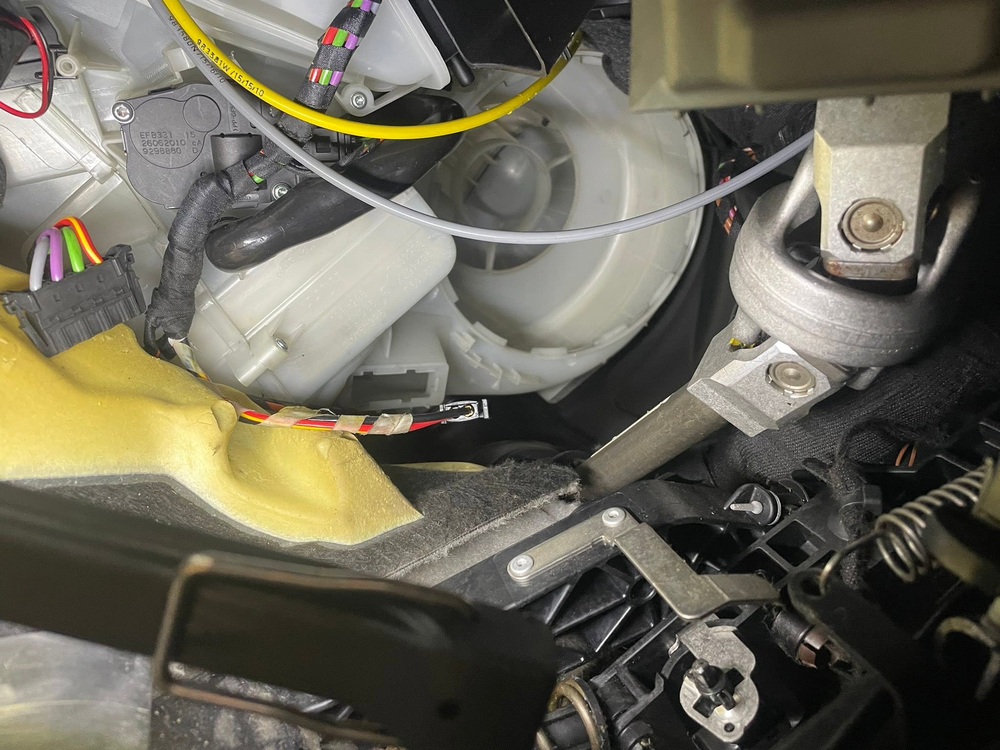 The heater and blower housing under a dashboard, opened up