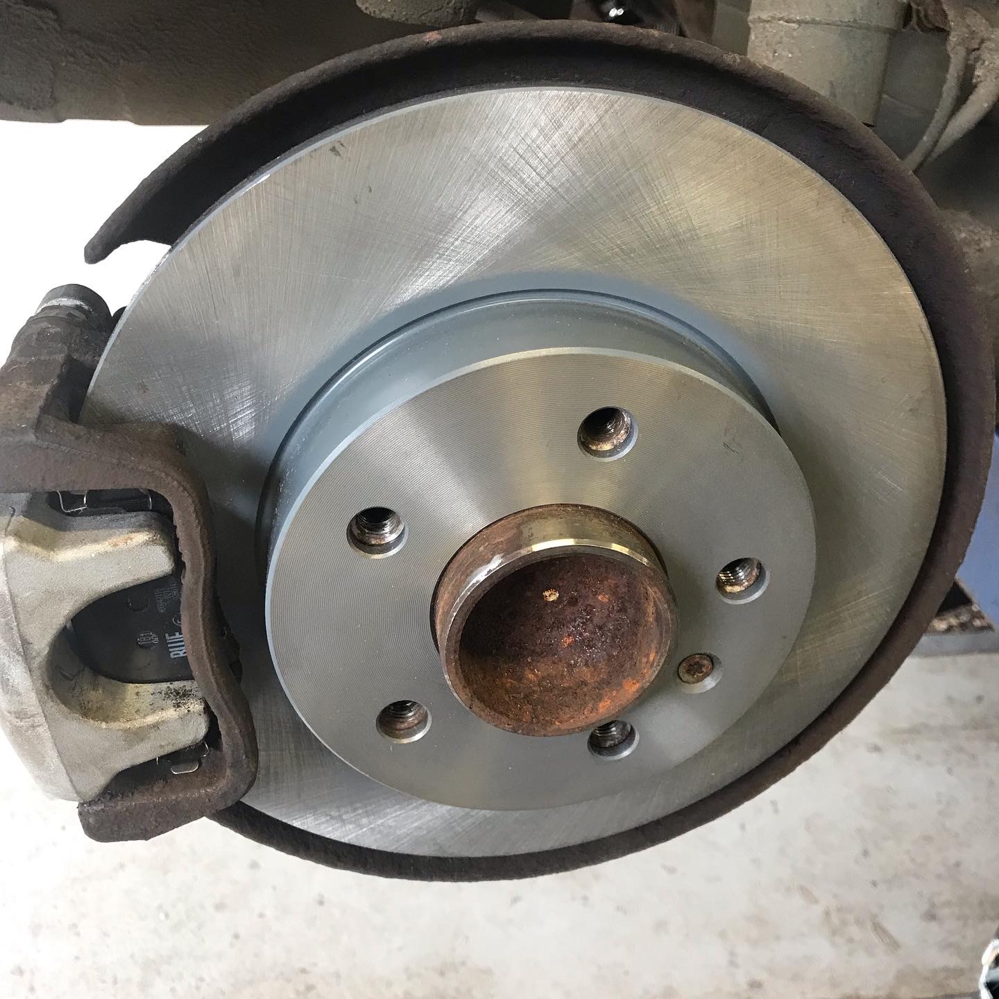 A clean brake disc fitted on the hub, caliper alongside